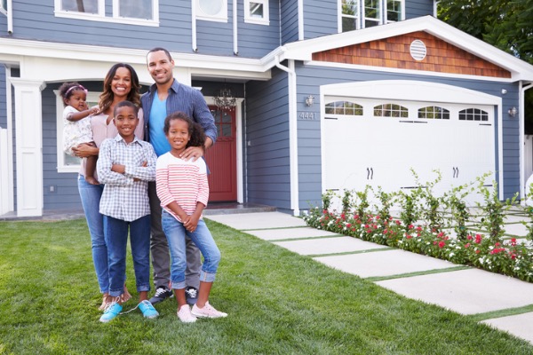 Family standing in front of home 